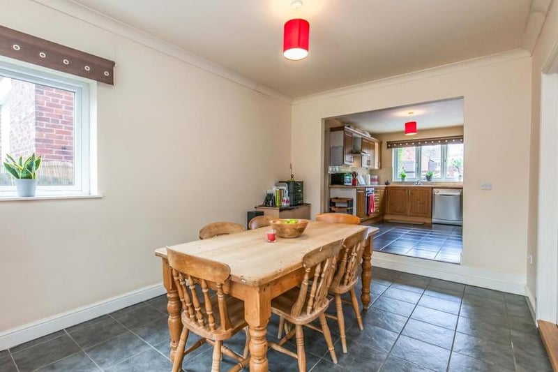 This dining area, just off the kitchen (background), boasts a ceramic tiled floor, coving to the ceiling and double-glazed window. There is ample space for a bigger dining table.