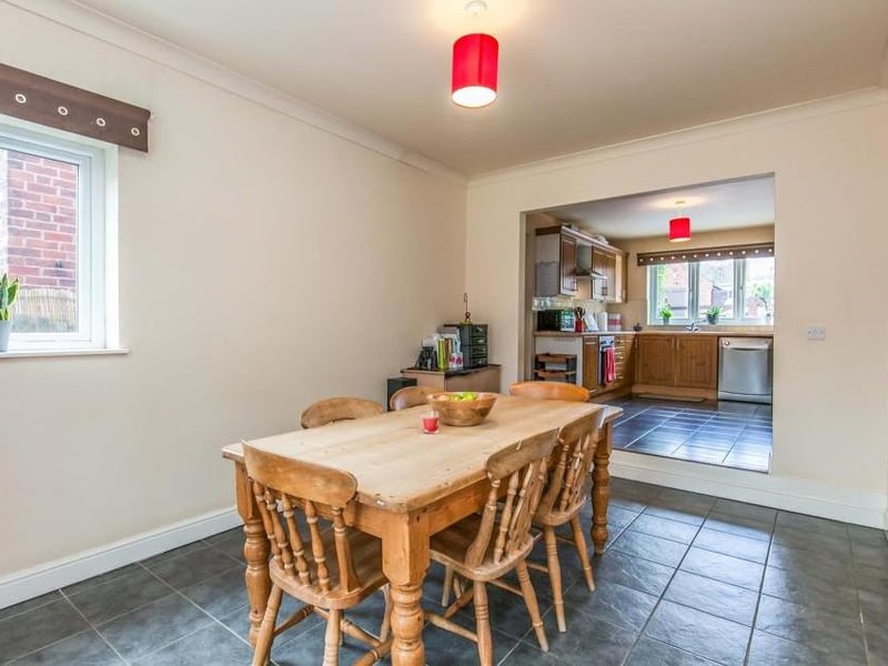 This dining area, just off the kitchen (background), boasts a ceramic tiled floor, coving to the ceiling and double-glazed window. There is ample space for a bigger dining table.