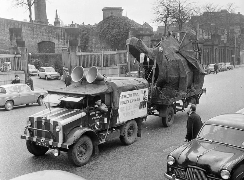 A Loch Ness Monster created by students of the Essex Institute of Agriculture for a demonstration for the Freedom Against Hunger Campaign travels down North Bridge in April 1964.