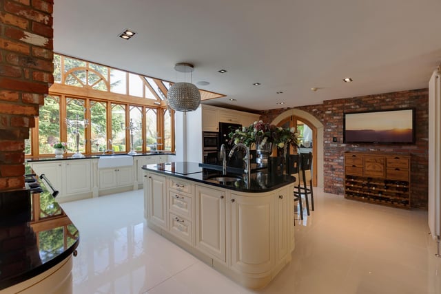 The beautiful country style kitchen has an open play layout, with a dining area, breakfast bar and huge side facing windows which overlook the garden. The kitchen boasts fitted base and wall units, with matching granite work surfaces and integrated appliances.