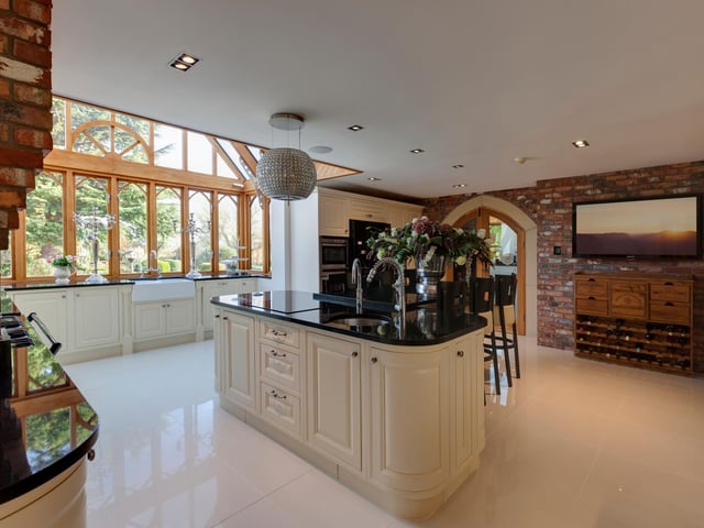 The beautiful country style kitchen has an open play layout, with a dining area, breakfast bar and huge side facing windows which overlook the garden. The kitchen boasts fitted base and wall units, with matching granite work surfaces and integrated appliances.