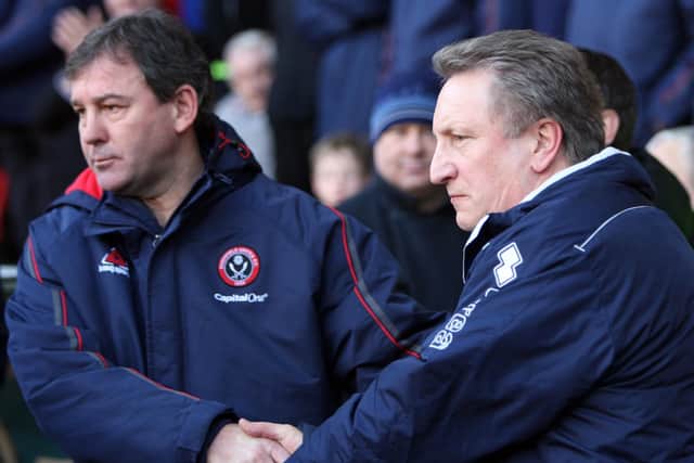Warnock, then in charge of Crystal Palace, shakes hands with Bryan Robson in the opposite dugout in December 2007, just months after he left the Blades (photo by Ross Kinnaird/Getty Images).