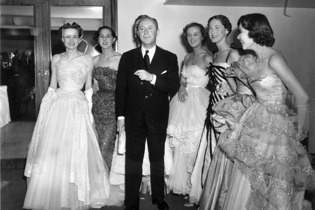 April 1950:  Fashion couturier Christian Dior (1905 - 1957), designer of the 'New Look' and the 'A-line', with six of his models after a fashion parade at the Savoy Hotel, London.  (Photo by Fred Ramage/Keystone/Getty Images)