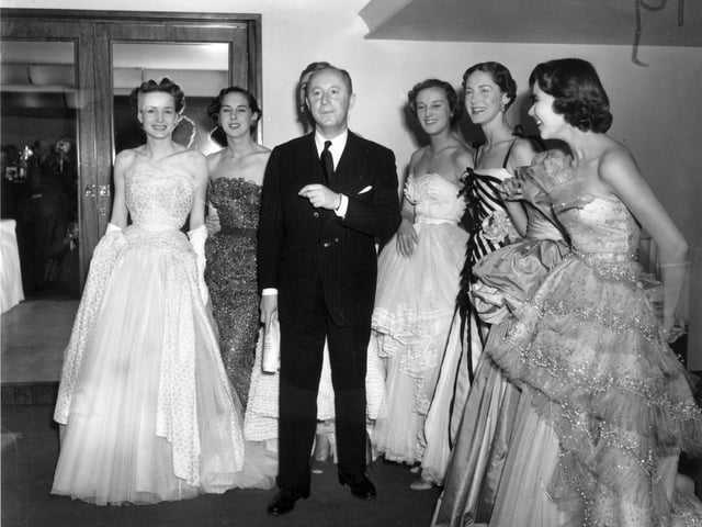 April 1950: Fashion couturier Christian Dior (1905 - 1957), designer of the 'New Look' and the 'A-line', with six of his models after a fashion parade at the Savoy Hotel, London. (Photo by Fred Ramage/Keystone/Getty Images)