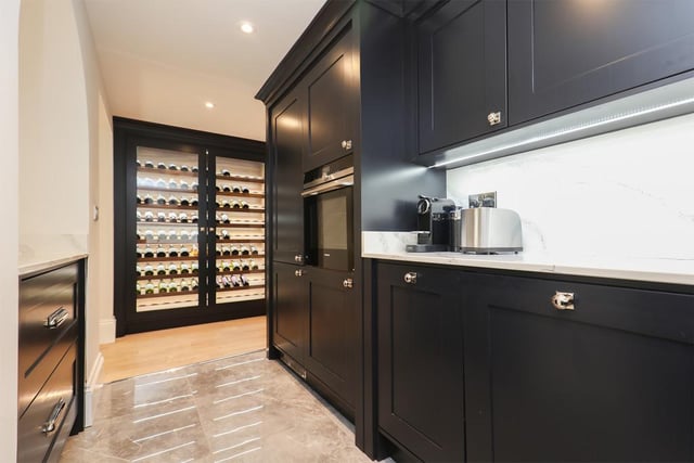 The galley kitchen comes with a range of integrated appliances, quartz worktops, Quooker hot tap and a floor-to-ceiling custom-made wine chiller.