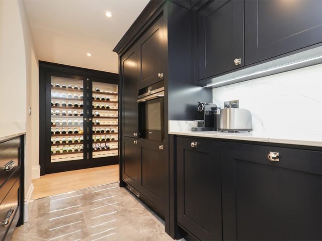 The galley kitchen comes with a range of integrated appliances, quartz worktops, Quooker hot tap and a floor-to-ceiling custom-made wine chiller.