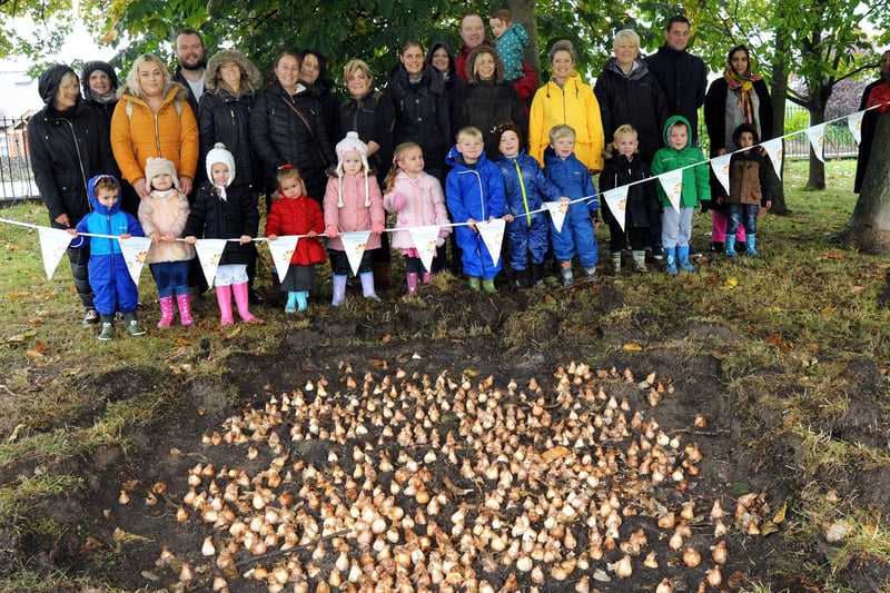 Staff, parents and pupils from the Highfield Hall Primary School nursery unit, pictured after helping the Friends of Stand Road Park plant 2,000 daffodil bulbs as part of Chesterfield in Bloom.
