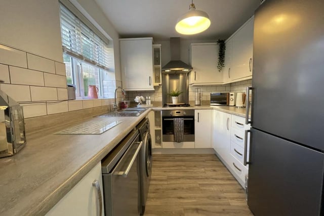 This is the busy main body of the kitchen, which features an integrated electric oven and gas hob, plus space for a fridge/freezer, a washing machine and dishwasher. Fitted wall and base units with drawer units are complemented by roll-top work surfaces and a one-and-a-half bowl stainless steel sink and drainer with mixer tap.