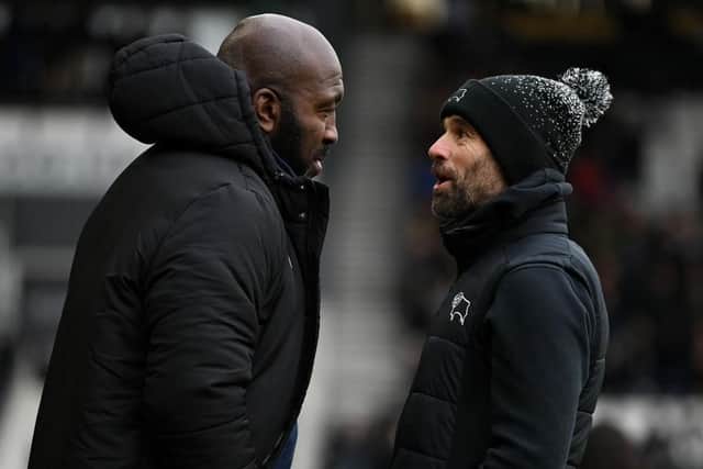DERBY, ENGLAND - DECEMBER 03: Sheffield Wednesday manager Darren Moore speaks with Derby manager Paul Warne during the Sky Bet League One between Derby County and Sheffield Wednesday at Pride Park Stadium on December 03, 2022 in Derby, England. (Photo by Gareth Copley/Getty Images)
