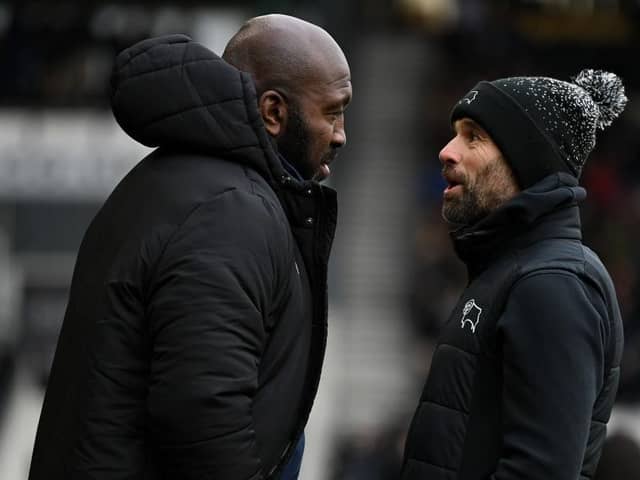 DERBY, ENGLAND - DECEMBER 03: Sheffield Wednesday manager Darren Moore speaks with Derby manager Paul Warne during the Sky Bet League One between Derby County and Sheffield Wednesday at Pride Park Stadium on December 03, 2022 in Derby, England. (Photo by Gareth Copley/Getty Images)