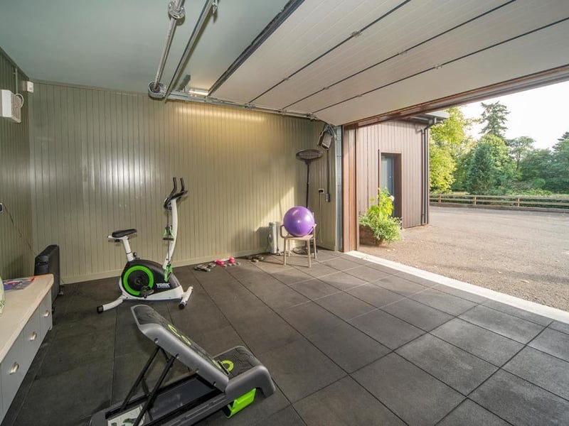 Fully insulated gym with fitted cupboards.