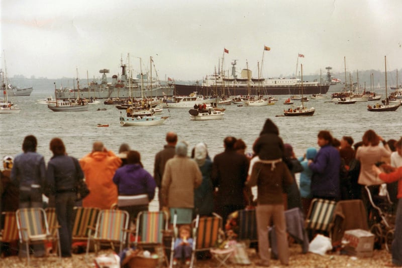 Spectators watch The 1977 Jubilee Fleet Review take place in the Solent from the beach. The News PP3652