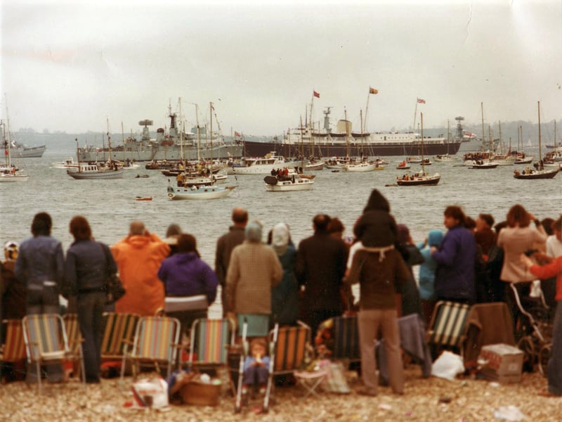 Spectators watch The 1977 Jubilee Fleet Review take place in the Solent from the beach. The News PP3652