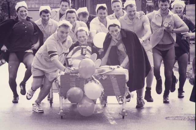 Weapons Engineering Mechanics from HMS Collingwood take charge with a charity bed push from Wykeham day Hospital to Fareham, 1993. The News PP5532