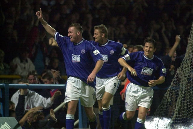 Celebrates in front of the Kop after his goal against Port Vale in September 2000.