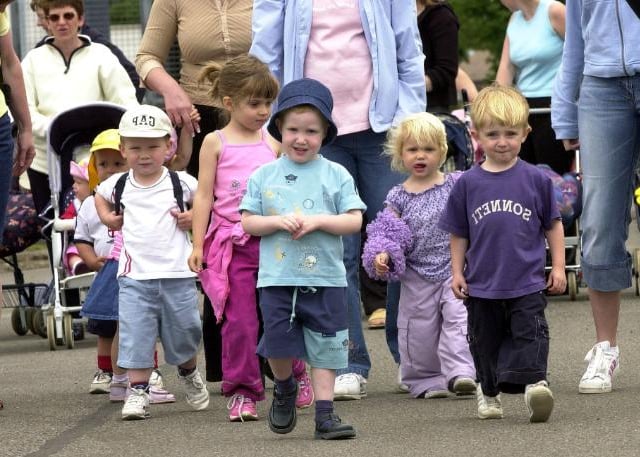 Children take part in a sponsored walk at Finningley in 2003.