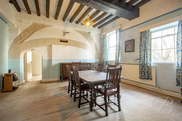 That's right this house has two dining rooms. This one has exposed brick and beams.
