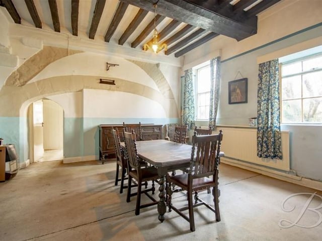 That's right this house has two dining rooms. This one has exposed brick and beams.