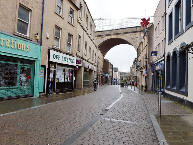A lone traffic warden patrols Church Street.