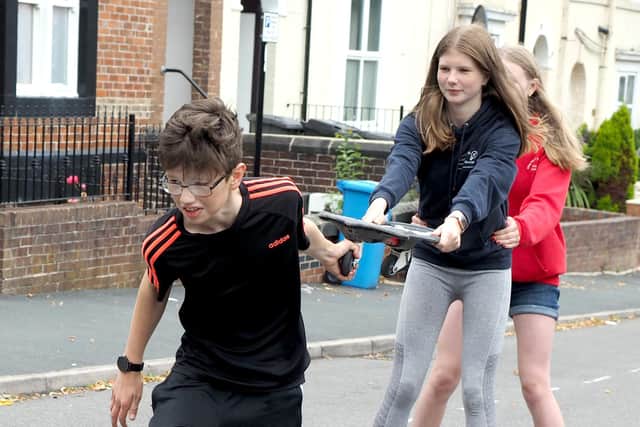 Pilot Play Street at Holberry Gardens in Broomhall: Tom James pulling sister Hannah and friend Rosanna Richardson.