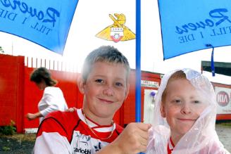 A couple of lads didn't mind the rain because they were excited for a Rovers match in 2004.