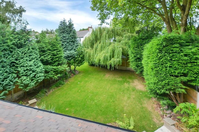 You've seen the front of the property. Now take a look at the back garden, which boasts substantial, well-kept lawns and an array of established shrubs and trees that help to create a private and spacious feel.