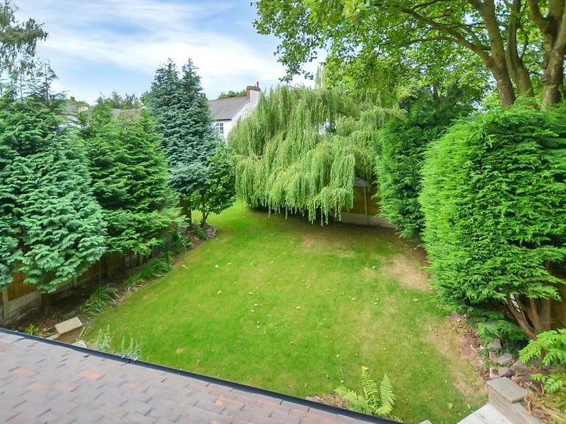 You've seen the front of the property. Now take a look at the back garden, which boasts substantial, well-kept lawns and an array of established shrubs and trees that help to create a private and spacious feel.