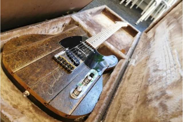 A guitar made from the Leadmil dancefloor signed by Arctic Monkeys.