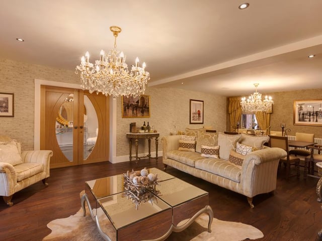 This elegant formal lounge and dining room is just one of six reception rooms and benefits from a front facing double glazed bay window which brings in plenty of light, a feature brick wall and stylish timber flooring.