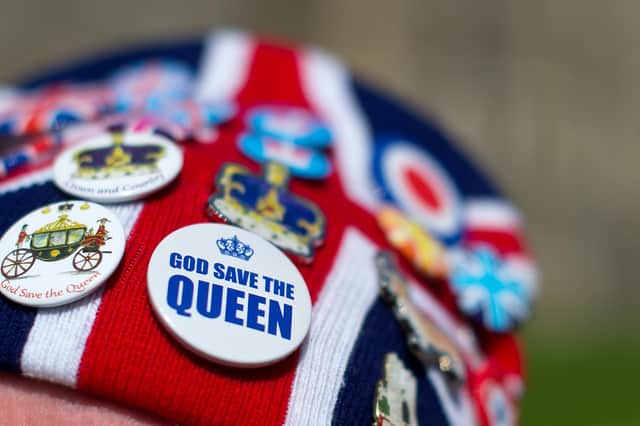 WINDSOR, ENGLAND - APRIL 19: Royal fan John Loughrey wears a hat with a badge with the slogan "God save the Queen" outside Windsor Castle ahead of Queen Elizabeth II's 90th birthday celebrations on April 19, 2016 in Windsor, England. The Queen's 90th birthday is on April 21 with celebrations taking place across the United Kingdom.  (Photo by Ben Pruchnie/Getty Images)