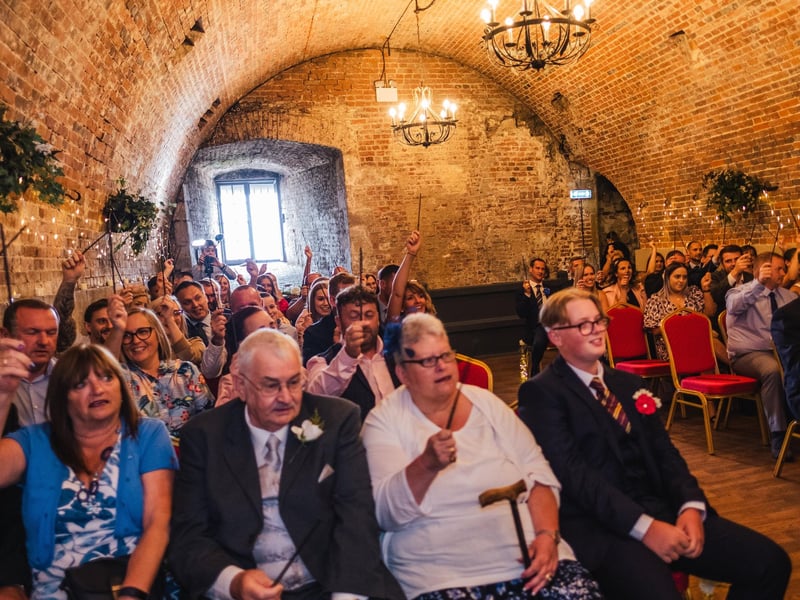 Guests holding wands at the wedding in the Square Tower, Old Portsmouth. Picture: Hayley Szczecinski from HS Photography
