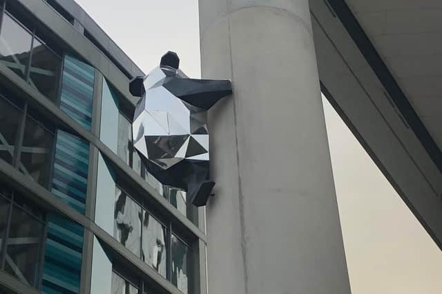 The roof panda has now been joined by another climbing up one of the building's pillars.