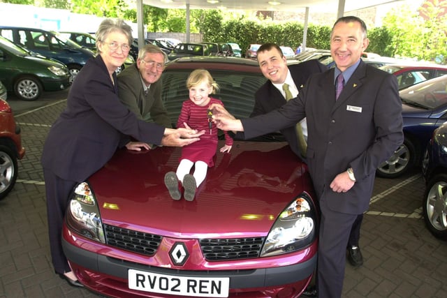 Hazel Bingham, husband John and grandaughter Isobel Allen, aged 4 received their Renault Clio from Reg Vardy new sales executive Craig Shaw and franchise manager Chris Edwards, right. The car was won in a free draw at the Go shop in Meadowhall in 2002