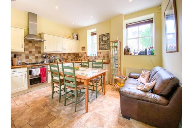 The spacious kitchen diner has a range of wall/base units, complimentary worktops and rear door leading to the garden.