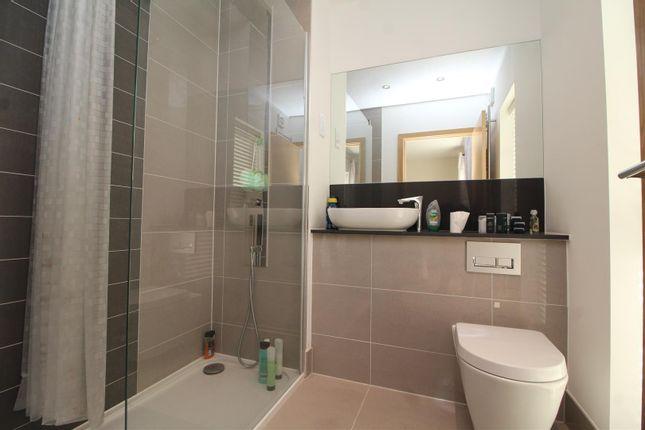 A neat and immaculately finished en-suite bathroom with a spacious shower cubicle and counter with basin.