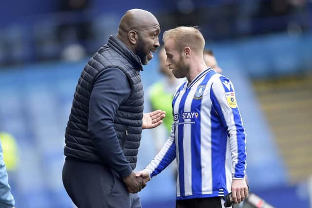Owls boss Darren Moore has a quiet word with his skipper Barry Bannan has he is replaced in the second half of their win over MK Dons. Pic Steve Ellis