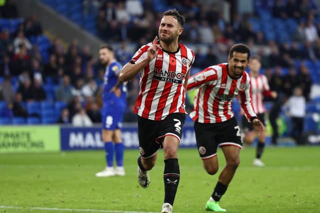 Sheffield United defender George Baldock celebrates scoring the first goal during the Sky Bet Championship match at the Cardiff City. Darren Staples / Sportimage