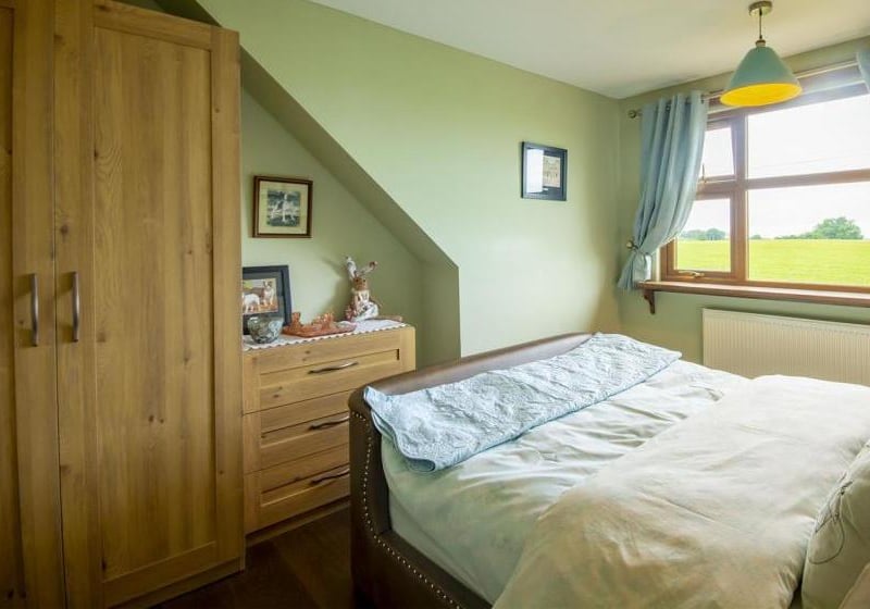 Another of the four bedrooms at the £600,000 home. Plenty of wardrobe space and a lovely view overlooking countryside at the back.