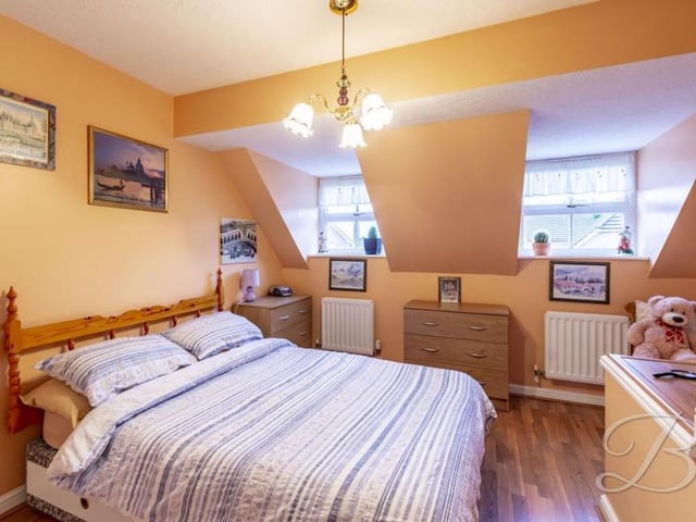 The main bedroom has a built-in wardrobe, storage cupboard, central-heating radiator and two windows to the front of the property. It is bigger than this photo suggests!
