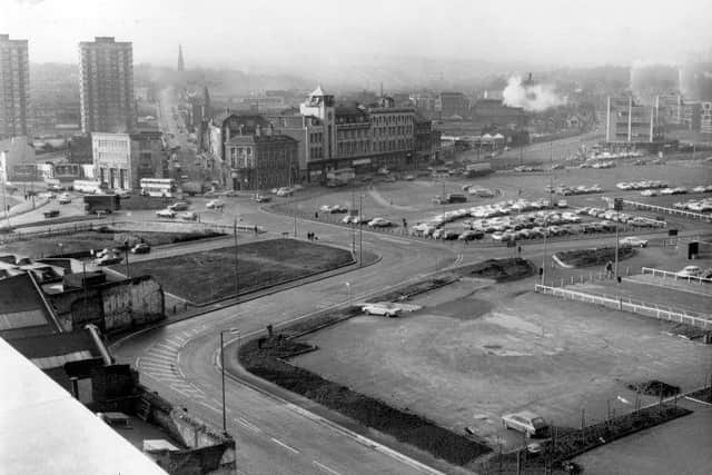 A 1970s scene showing a derelict area at the bottom of the Moor and a roundabout at the junction of St Mary's Gate and London Road. In the background, Cemetery Road heads straight up the hill.