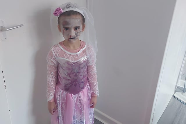 Mya, age 6, says "Boo!" as a bride.