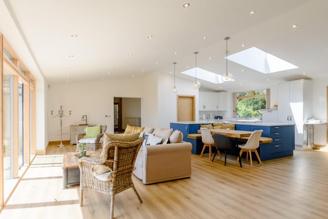 The hallway leads into the "beautiful and spacious lounge" area that is flooded with light via the floor to ceiling windows and sliding doors that lead to the rear garden and patio area.