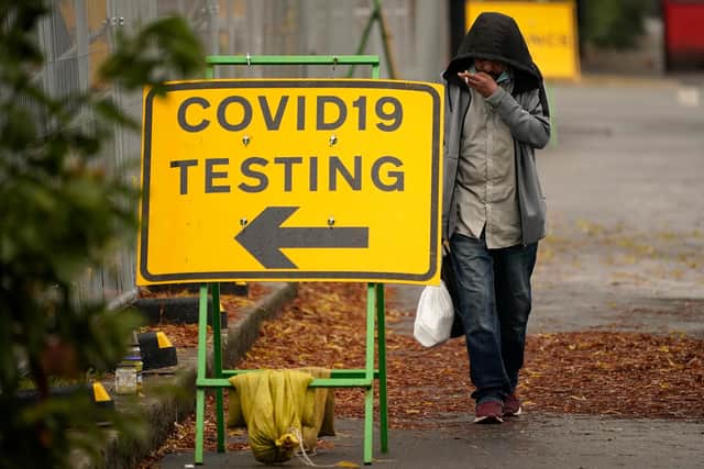 A man walks past a Covid-19 testing site on October 22, 2020 in Sheffield (Photo by Christopher Furlong/Getty Images)