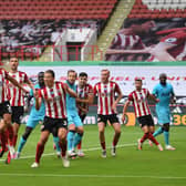 Sheffield United's defenders, including Chris Basham (fourth from left), go to work against Spurs last season: OLI SCARFF/POOL/AFP via Getty Images