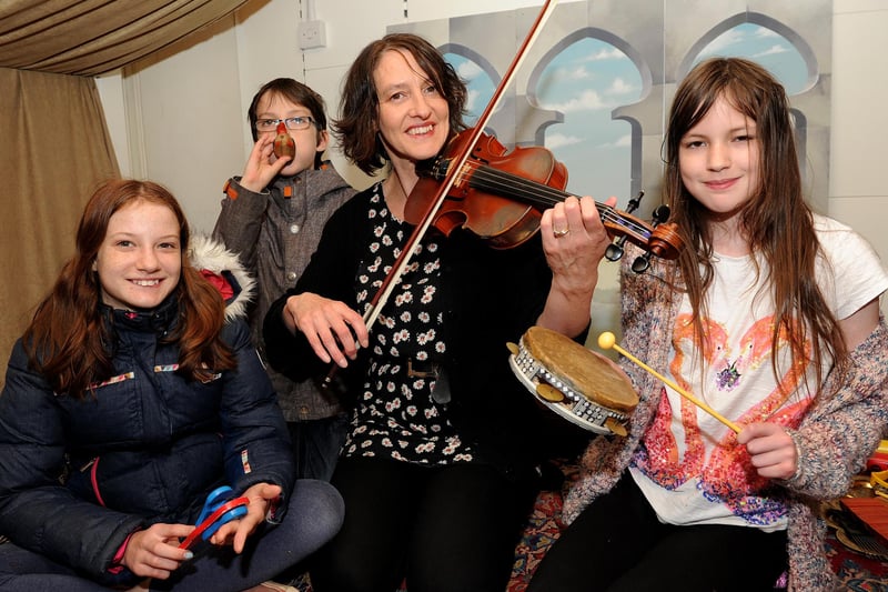 Mandy Johnson tells a story through music with (l-r) Hattie, 12, Ivor, 11 and Polly Johnson, 11, at a stories from a Persian carpet event held at The Moor Market as part of half term activities in 2016