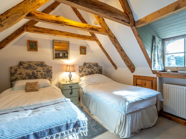 The bedrooms boast exposed rafters