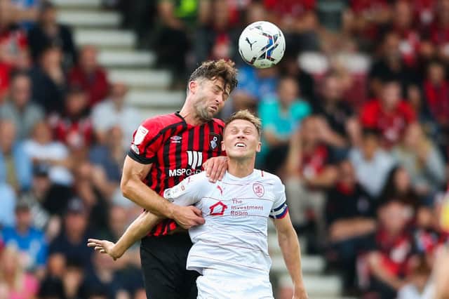 Bournemouth's Gary Cahill climbs high over Barnsley's Cauley Woodrow to head the ball clear. Mark Kerton/PA Wire.