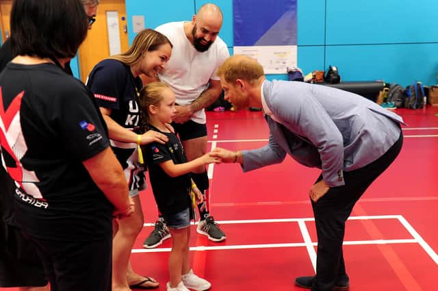 The Duke of Sussex Prince Harry meets competitor Mitch Mitchell's daughter Poppy, aged 7, at the Invictus Games UK Trials at the English Institute of Sport, Sheffield on July 25, 2019