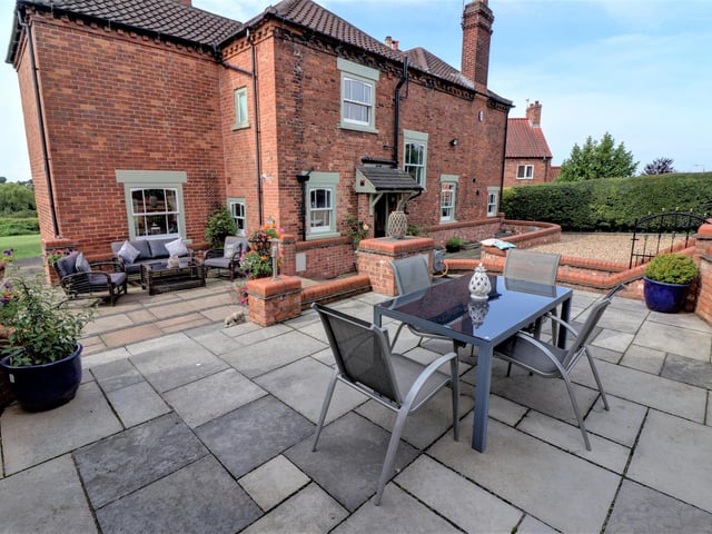At the rear you have a large detached double garage which has electric controlled doors, power and lights, raised patio area with brick-built BBQ, large workshop with storage power and lights and two further brick-built tool sheds.