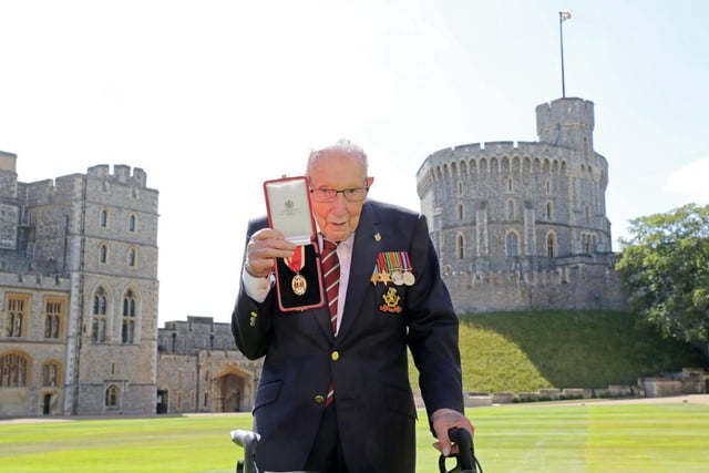 Sir Tom Moore poses with his medal after being made a Knight Bachelor during an investiture at Windsor Castle. (Photo by Chris Jackson / POOL / AFP)